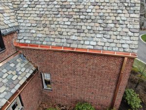 copper gutters on a home with a slate roof installed