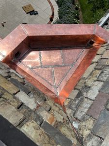 finished copper gutter basin on slate roof